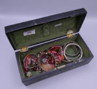 A quantity of miscellaneous jewellery in a lacquered box.