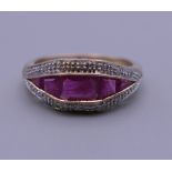 An Art Deco style 9 ct gold ruby and diamond ring. Ring size O. 3.4 grammes total weight.