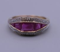 An Art Deco style 9 ct gold ruby and diamond ring. Ring size O. 3.4 grammes total weight.