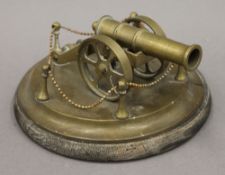 A small brass model of a cannon. 8.5 cm high.