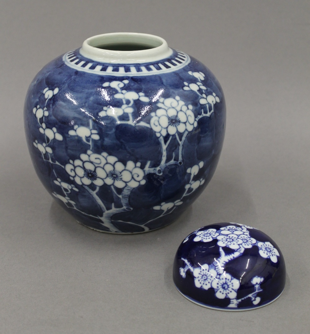 Two 19th century Chinese blue and white 'prunus blossom' vases and covers. The tallest 28 cm high. - Image 4 of 22