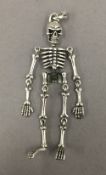 A pendant formed as a skeleton. 8 cm high.