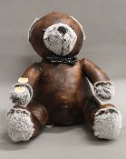 A leather doorstop formed as a teddy. 31 cm high.