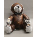 A leather doorstop formed as a teddy. 31 cm high.