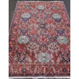 A large red ground rug. 215 x 318 cm.