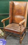 A late 19th/early 20th century Arts and Crafts leather covered wing back armchair.