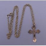 A 9 ct gold crucifix on a 9 ct gold chain. The crucifix 2.5 cm high. 2.