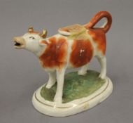 A 19th century Staffordshire cow creamer. 18 cm long.