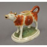 A 19th century Staffordshire cow creamer. 18 cm long.