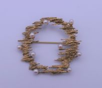 A 9 ct gold seed pearl set brooch. 4 cm wide. 6 grammes total weight.