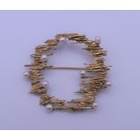 A 9 ct gold seed pearl set brooch. 4 cm wide. 6 grammes total weight.