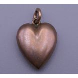 An Edwardian rose gold puff heart pendant. 2 cm high. 1.