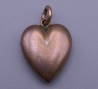 An Edwardian rose gold puff heart pendant. 2 cm high. 1.