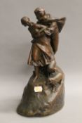 A late 19th/early 20th century patinated bronze figural group, indistinctly signed. 33 cm high.