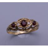 A 9 ct gold diamond and ruby ring. Ring size S. 2.1 grammes total weight.