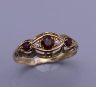 A 9 ct gold diamond and ruby ring. Ring size S. 2.1 grammes total weight.