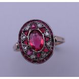 An antique unmarked gold, ruby and diamond ring. Ring size Q. 2.7 grammes total weight.