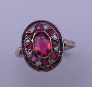 An antique unmarked gold, ruby and diamond ring. Ring size Q. 2.7 grammes total weight.