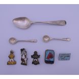 A small quantity of Butlins badges, a pair of silver salt spoons and a silver teaspoon.