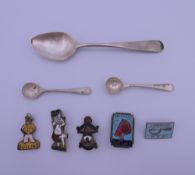 A small quantity of Butlins badges, a pair of silver salt spoons and a silver teaspoon.