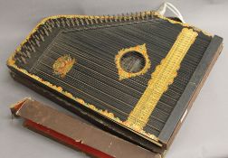 A boxed Menzenhauer's American guitar zither. 43 cm wide.