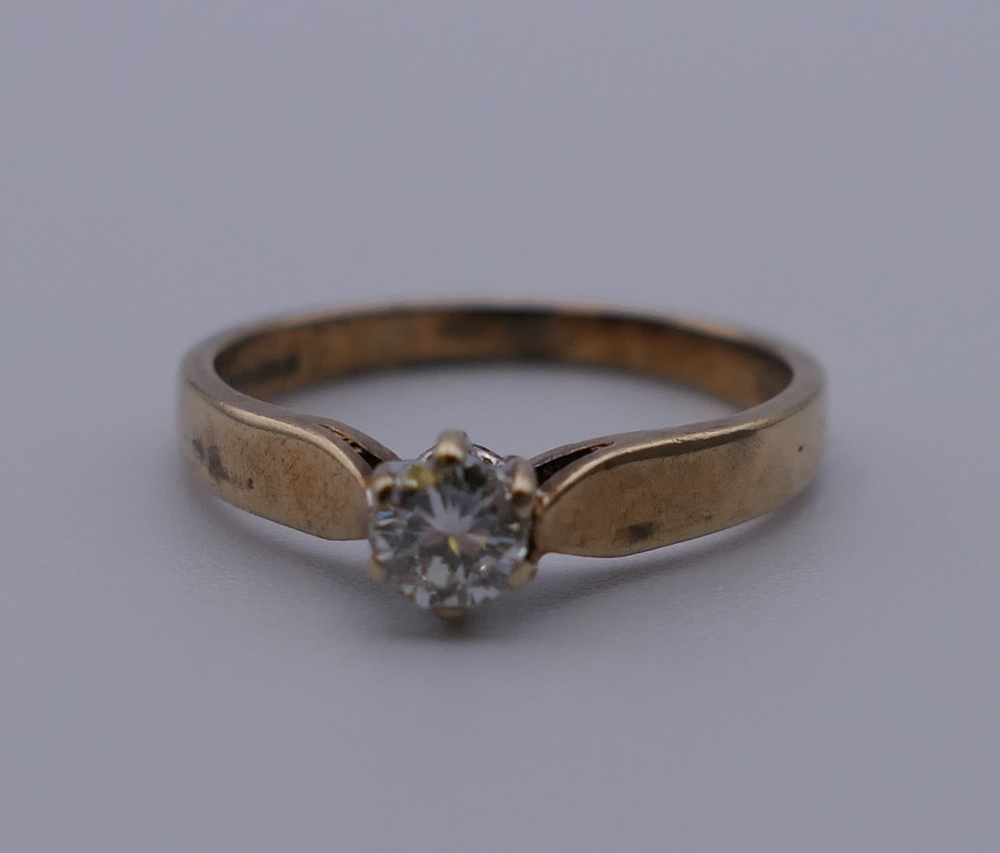 A 9 ct gold diamond solitaire ring. Ring size J. 1.4 grammes total weight.