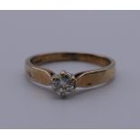 A 9 ct gold diamond solitaire ring. Ring size J. 1.4 grammes total weight.