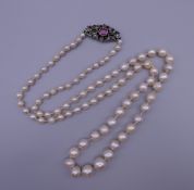 A vintage freshwater pearl necklace with an unmarked gold, diamond and ruby clasp. 67 cm long.