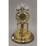 A brass anniversary clock under a glass dome. 28 cm high.