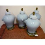 Set of four ceramic table lamps with lion mask handles