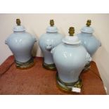 Set of four ceramic table lamps with lion mask handles