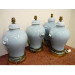 Set of four ceramic table lamps with lion mask handles
