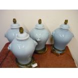 Set of four ceramic table lamps with lion mask handles