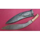 Early - mid 20th C Kukri knife with 114 inch blade, two piece wooden grips leather sheath