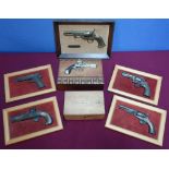 Wooden cigar box topped with a figure of a flintlock pistol, a set of four framed plaques of various