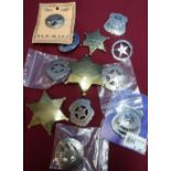 Selection of various reproduction metal American Police Marshall and Sheriff badges