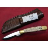 Small Bear USA sheath knife with 2 inch blade, two piece Sambar horn grips and leather sheath