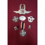 Selection of various German military badges including Merit Crosses, lapel badges, etc