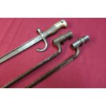 Two 19th C socket triangular form bayonets and a French bayonet, the top strap marked 1880 (3)