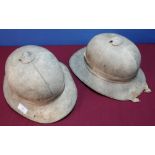 Two circa WWII period British military pith helmets, one with leather liner and chin strap marked