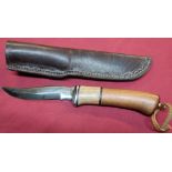 Colt Sheffield sheath knife with 4 1/4 inch curved blade, wooden grip and leather belt sheath