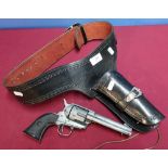 Tooled leather Western style gun holster belt with a replica model single Action Army .45 1874