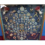 Framed and mounted display case of Victorian and later military cap badges and insignia including
