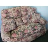 Victorian style two seat sofa with rolled arms and tapestry upholstery on turned wooden supports (