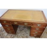Quality reproduction mahogany Campaign style twin pedestal desk with leather insert top, brass inset