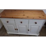 Modern pine and cream painted dresser base with three drawers above three paneled cupboard doors (