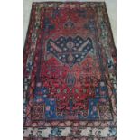 20th C traditional patterned Persian style rug with blue central medallion and animal patterned