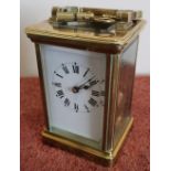 French brass cased striking carriage clock with beveled edged glass panels, complete with key (