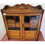 Edwardian oak free standing table cabinet enclosed by two bevelled edge glazed and paneled