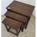 Nest of three oak occasional tables on turned supports